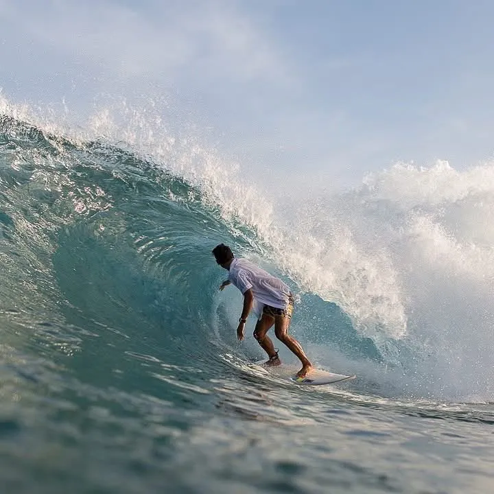 Loxy pulling into a clean barrelling right over the reef at Lacerations, Nusa Lembongan