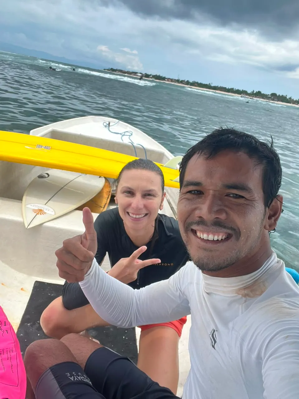Loxy and a smiling student giving a thumbs up and a shaka after a surf session at Nusa Lembongan